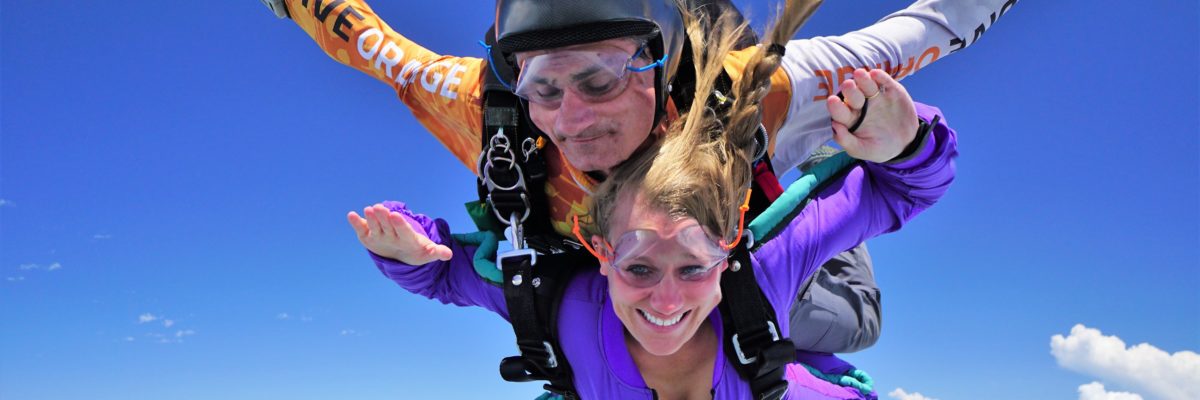 tandem skydiver beginning her journey to a skydiving license at Skydive Orange