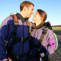 couple kissing before skydive