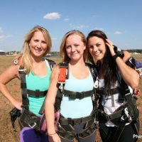 three friends in landing area at Skydive Orange