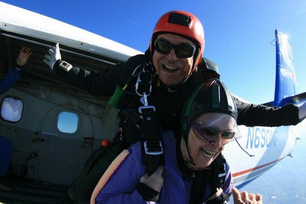 older woman exist skydiving plane