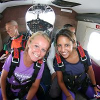 tandem skydiving students in jump plane