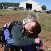 Tandem student hugging instructor after landing at Skydive Orange in Virginia