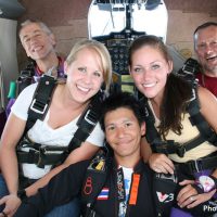 three friends in skydiving plane